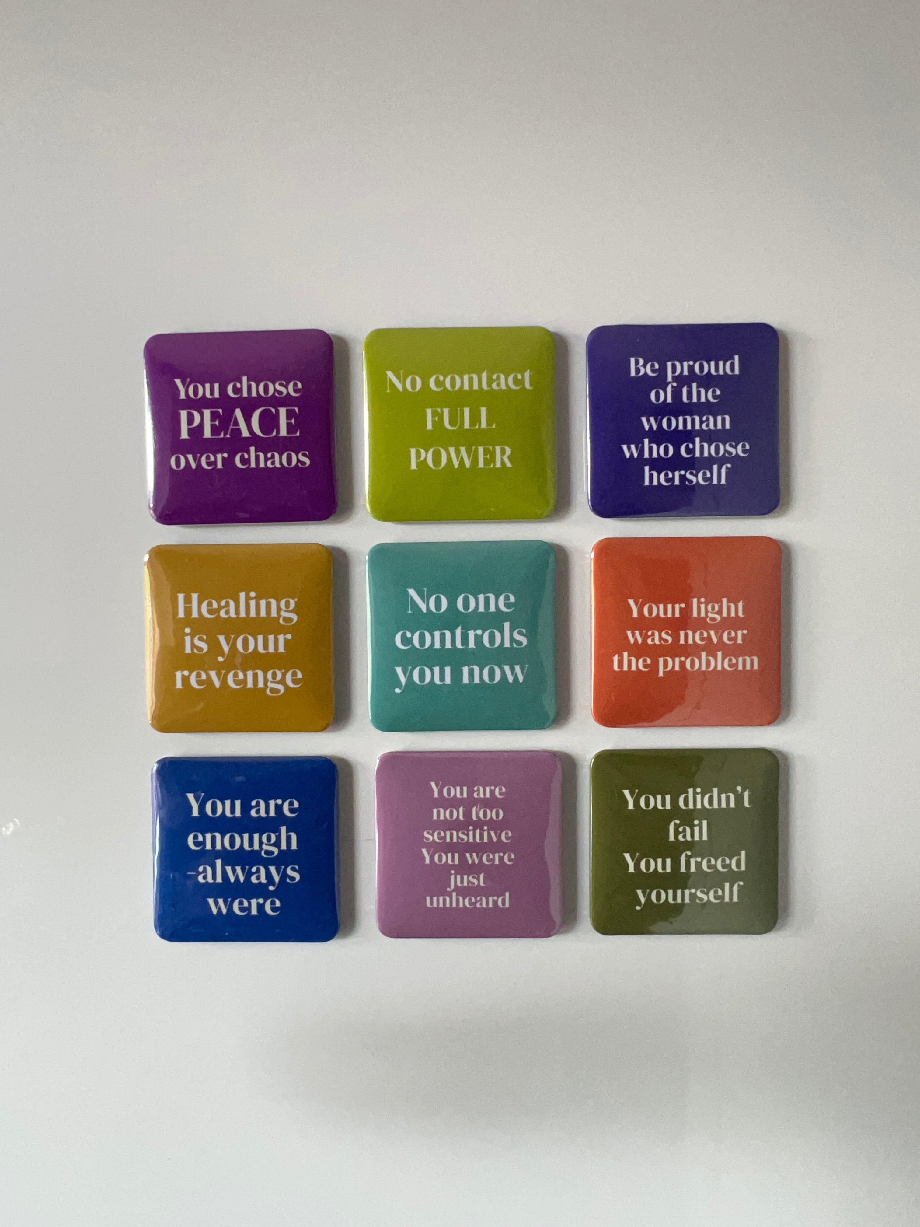 Set of colorful square fridge magnets with motivational phrases.