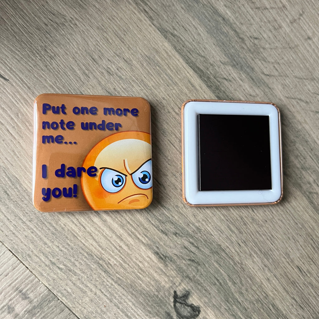 Emotional emoji magnet with text on a wooden surface